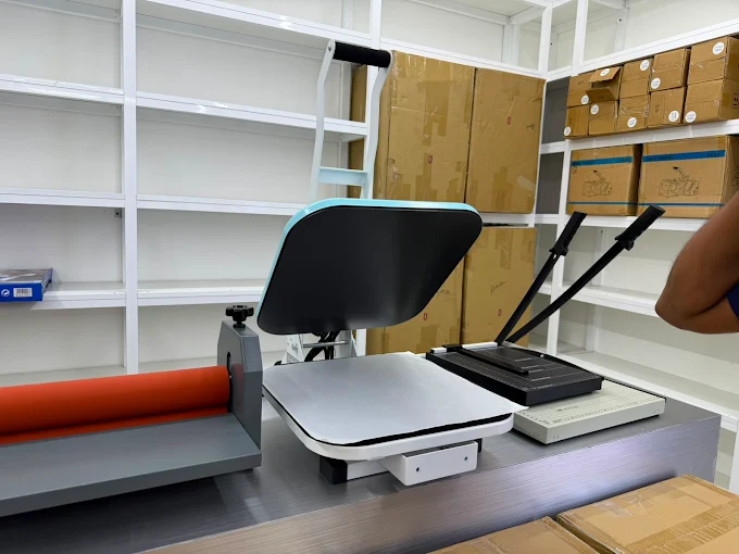 Heat press and guillotine cutter at LYCO Print Solutions